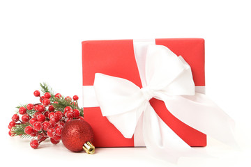 Wall Mural - Gift box with red berries and bauble toy isolated on white background