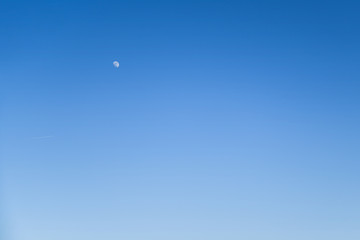 Wall Mural - cear blue sky without clouds with moon and airplane for background for nature background