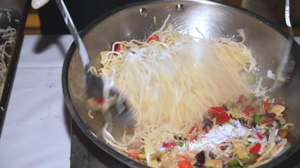 Wall Mural - Cook prepares wok noodles with vegetables