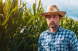 © Bits and Splits - Serious corn farmer portrait in cultivated field looking at camera