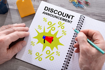 Discount announcement concept on a notepad