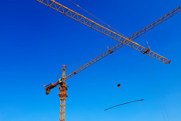 Tower crane arm in the blue sky background