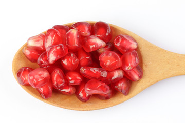 Red Pomegranate seed wooden spoon white background