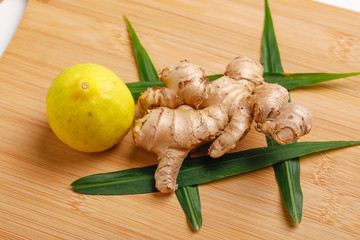 Wall Mural - Lemon and ginger on wooden background 