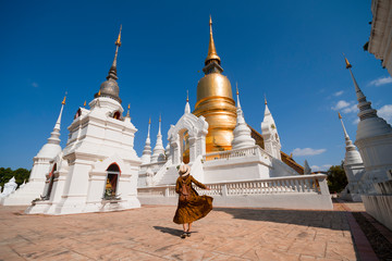 Woman hipster is sightseeing inside Wat Suan Dok in Chiangmai, Thailand.