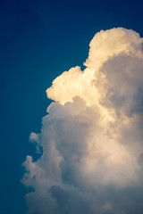 big white storm cloud in deep blue sky