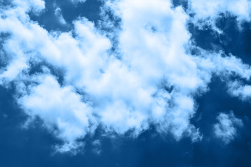 beautiful blue sky with a white clouds in classic blue trendy color. background. Color of the year 2020.