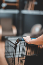 Close Up Hand Of Female Shopper With Trolley, Shopping Cart At Supermarket.