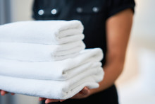 Maid With Fresh Towels In Hotel Room