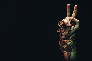 Fototapete - Human hand are chained in chains isolated on black background.