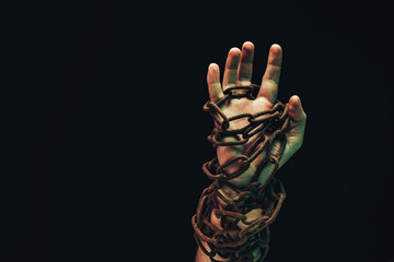 Fototapete - Human hand are chained in chains isolated on black background.