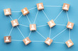 © ink drop - Wooden blocks connected together on a blue background. Teamwork concept