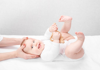 little baby receiving osteopathic treatment of head and neck