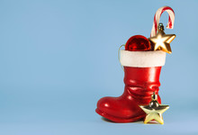 Santa Boot With Candy Cane And Baubles. Christmas. New Year Background With Copy Space