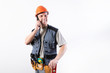 © Artsiom P - Builder talking on a cell phone.