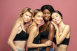 © Beauty Agent Studio - Multi Ethnic Group of Womans with diffrent types of skin standing together and looking on camera. Diverse ethnicity women - Caucasian, African and Asian against pink background