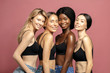 © Beauty Agent Studio - Multi Ethnic Group of Womans with diffrent types of skin standing together and looking on camera. Diverse ethnicity women - Caucasian, African and Asian against pink background