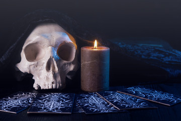 Wall Mural - Close up of scary skull, burning candle and tarot card. Divination. Esoteric concept.