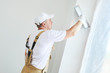 Painter with putty knife. Plasterer smoothing esconson surface at home renewal