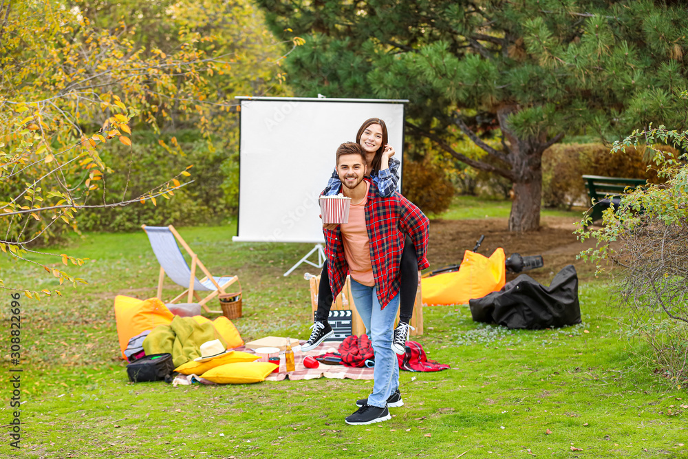 Young couple having fun in outdoor cinema