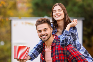 Sticker - Young couple having fun in outdoor cinema