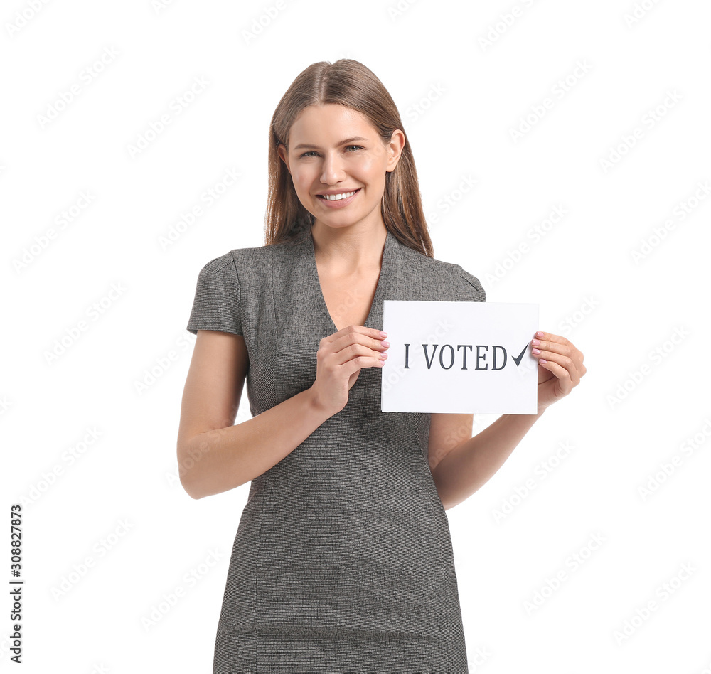 Young woman holding paper with text I VOTED on white background