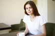 © SHOTPRIME STUDIO - woman sitting on sofa with cup of coffee