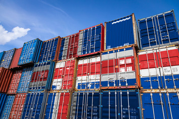 the national flag of iceland on a large number of metal containers for storing goods stacked in rows