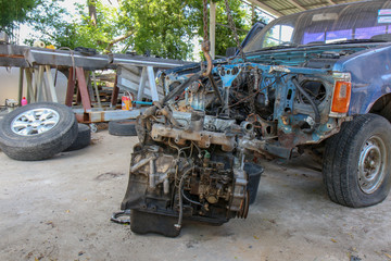 Poster - The Old Car engine on crane hook in garage repair service, outdoor.