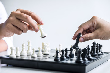 businessman and businesswoman playing chess and thinking about strategy crash overthrow the opposite