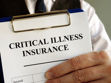 Critical Illness Insurance Application Form In The Hands.