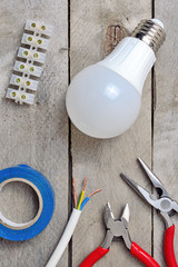 lamp and electric tool on a wooden background. top view.