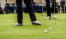 Golfer Legs At Golf Tournament Practice Swing With Golf Club.
