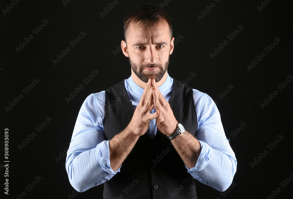 Portrait of stylish young man on dark background