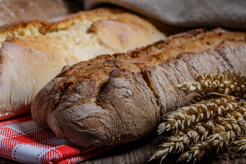 Assortment of baked bread on wooden table background ЮFresh fragrant bread on the table. Food concept.