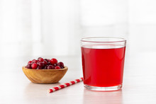 Glass With Fresh Organic Cranberry Juice And Red Cranberries.