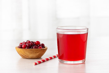 Wall Mural - Glass with fresh organic cranberry juice and red cranberries.