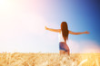 © Dmytro Sunagatov - Happy woman enjoying the life in the field. Nature beauty, blue sky,white clouds and field with golden wheat. Outdoor lifestyle. Freedom concept. Woman jump in summer field