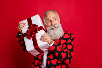 Poster - Close-up portrait of his he nice attractive cheerful cheery white-haired guy cherub holding in hand gift congrats guessing what's inside isolated on bright vivid shine vibrant red color background