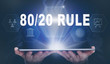 © Duncan Andison - Businessman holding a computer tablet display projecting a 80 / 20 Rule concept.