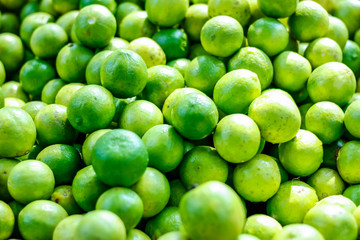 Green and yellow lemon in indian vegetable market 