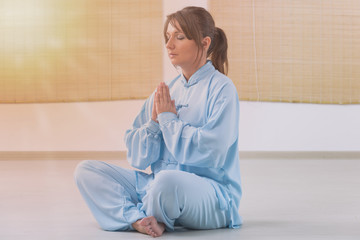 Wall Mural - Woman doing qi gong tai chi exercise