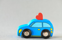 Blue Toy Car With A Heart On The Roof. High Resolution Photo.