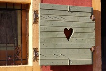 Wooden Shutters On Windows. Love And Peace Concept. Heart Sign