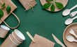 Recycled Eco-friendly disposable tableware made of paper on a green background. Wooden spoons, fork, knive, with paper cups, box, bamboo chopstic.