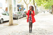 © Mangostar - Stylish woman with smartphone and coffee to go. Full length view of beautiful fashionable young African American woman with mobile phone and paper cup walking outdoors. Style concept