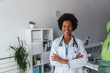 © lordn - Portrait of female African American doctor standing in her office at clinic