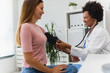 © lordn - Female African American doctor measuring blood pressure of a young woman