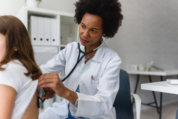 Doctor examining child with stethoscope. Respiratory disease diagnostics and treatment