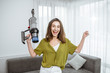 © rh2010 - Portrait of a young and happy woman with cordless vacuum cleaner, enjoying housework at home. Concept of an easy cleaning with wireless tools